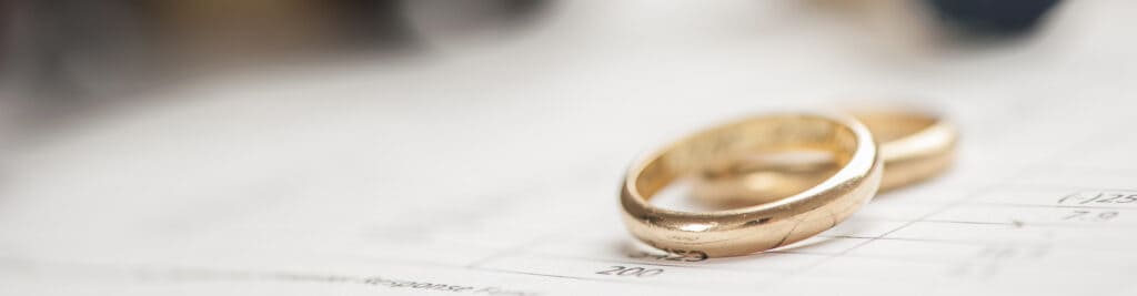 Two wedding rings on divorce paperwork